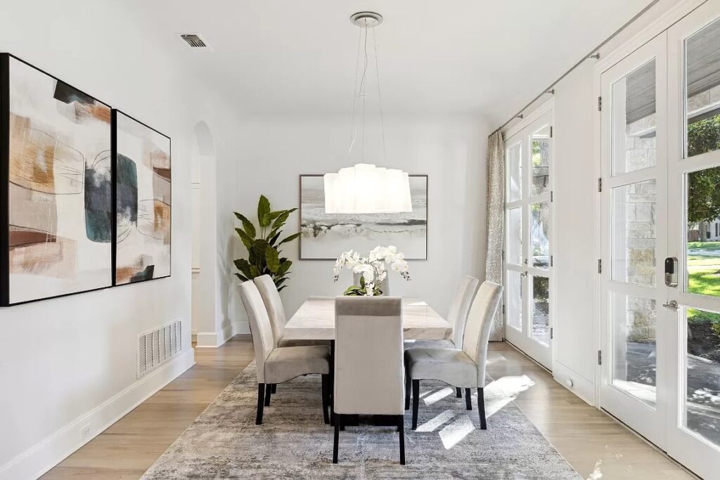 Dining room staged with large table, oversized artwork