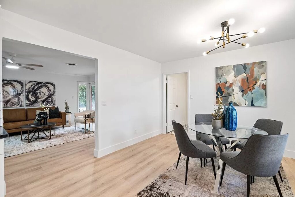 Home Staging of kitchen seating area with round table and four grey chairs with abstract artwork