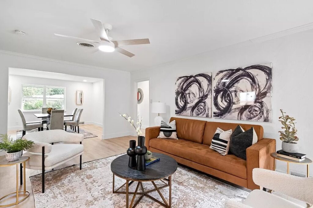Modern home staging in Dallas Fort Worth with a tan leather sofa and black and white accessories