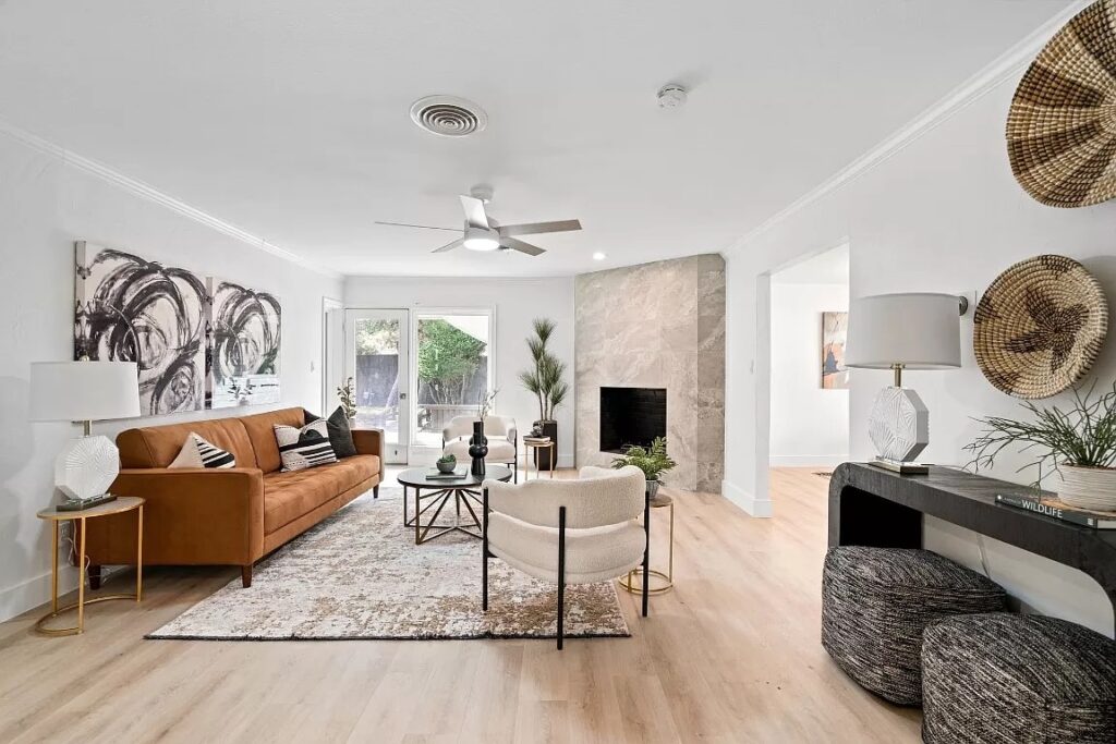 Modern home staging in Dallas Fort Worth with a tan leather sofa and black and white accessories