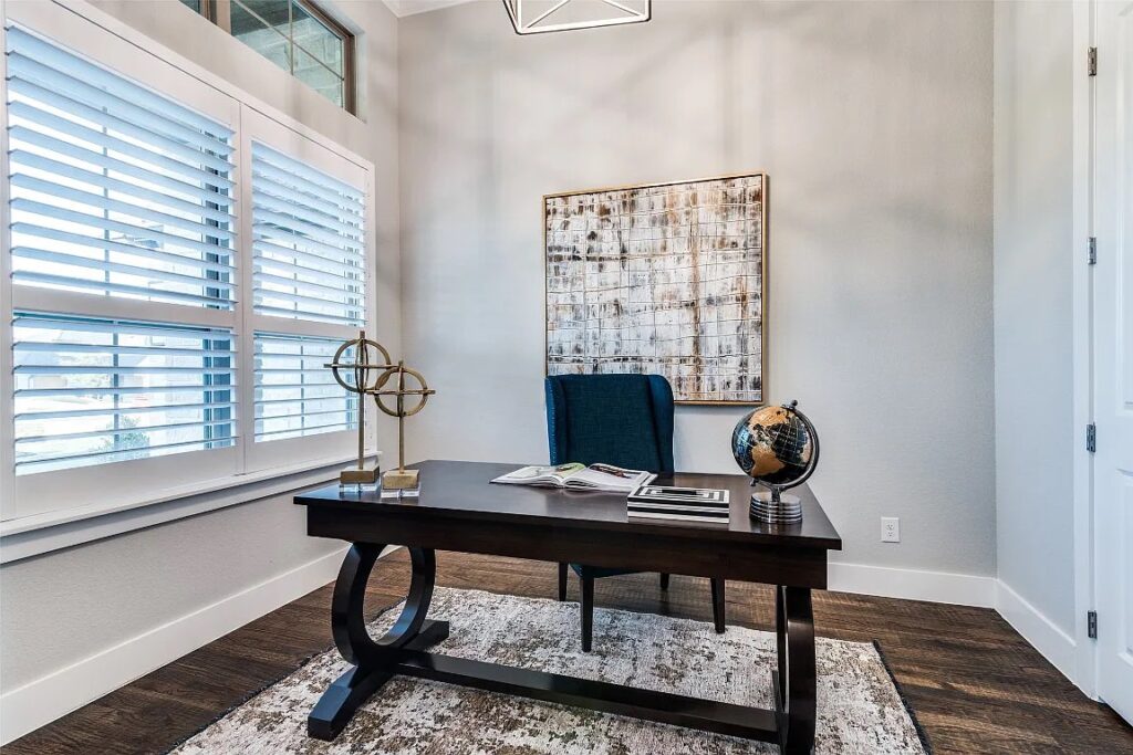 Home Staging Dallas Fort Worth of a home office with dark desk and large art on the wall.