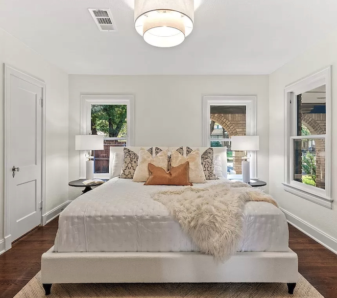 Bedroom is staged with light and modern furnishings