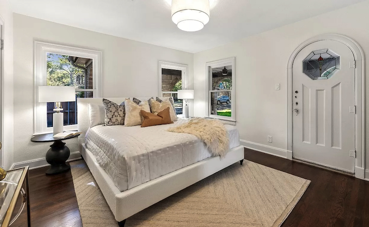 Bedroom staged with light and modern furnishings to showcase this Tudor style home