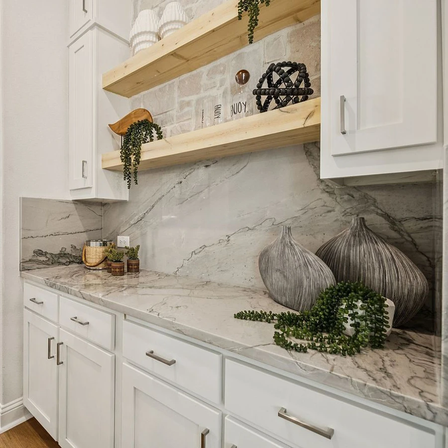 Kitchen area staged with grey vases, faux greenery and glasses