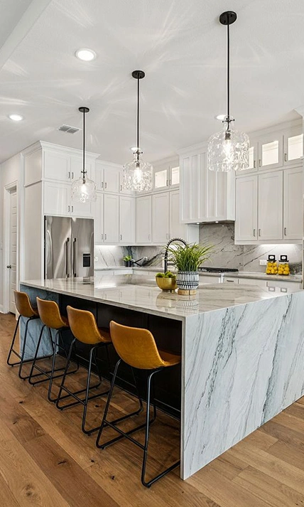 Kitchen staged with four low back leather barstools, greenery and kitchen accessories