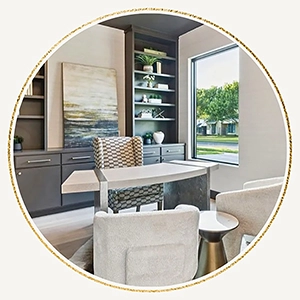 Circular vignette of a staged home office featuring a modern curved white desk, a checkered fabric desk chair, two white accent chairs, built-in grey cabinetry, and a large window