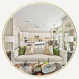 Living area with a light beige sofa, green and beige colored pillows, light wood coffee table and accessories