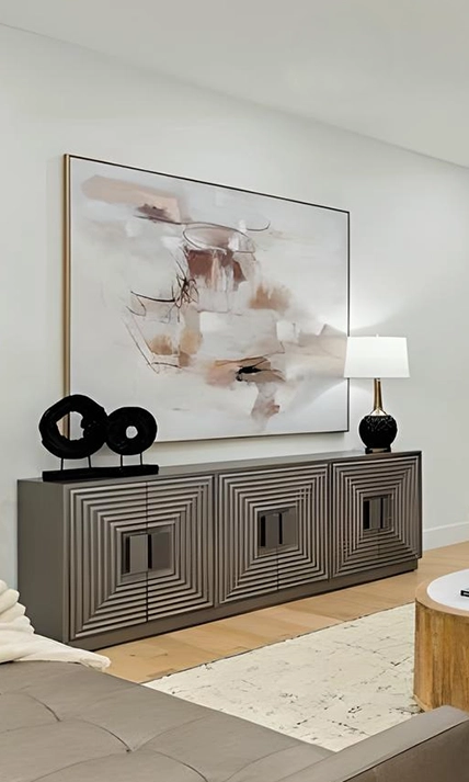 Close up of a modern sideboard with geometric patterned doors, black lamp and large art