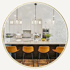 Staged kitchen with modern lowback leather barstools and greenery accents