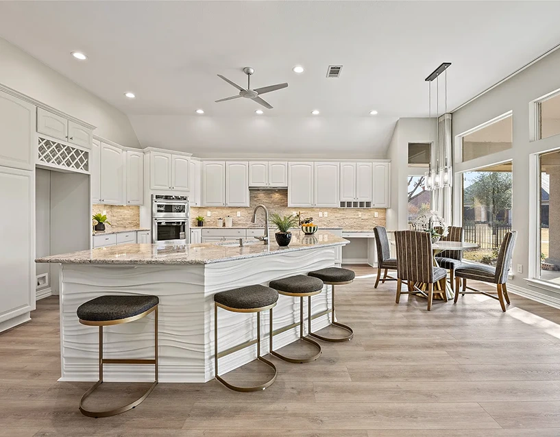 Staged kitchen with barstools, dining table, chairs and accessories