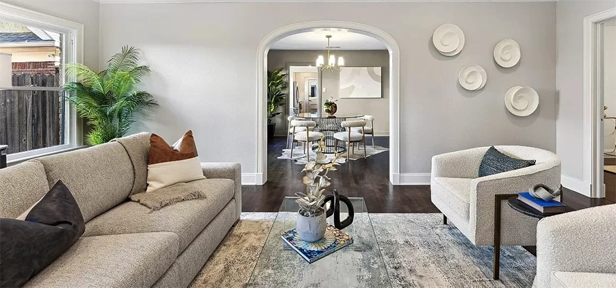 View from living room through an archway showing the dining room and kitchen areas