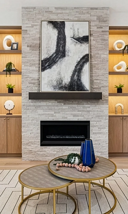 View of a Prestonwood living room featuring a stone fireplace flanked by illuminated oak shelving and modern furniture on a geometric rug