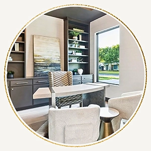 A circular view of a modern home office staging including a curved desk with a patterned chair, gray built-in shelving filled with decor, and a large window providing natural light