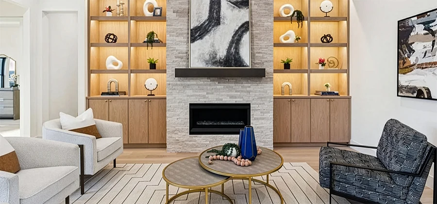 Close-up of a contemporary living room fireplace with a stacked stone facade, a dark wood mantel, and large-scale black and white abstract art