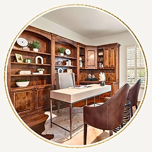 A circular photo focusing on the intricate dark wood shelving and the workspace of the home office, emphasizing the classic architectural details.