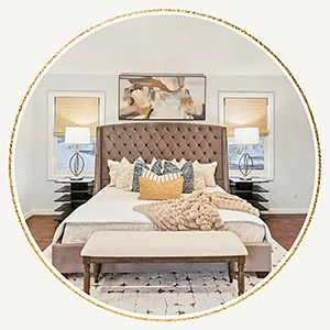 Staged bedroom with upholstered bed and lush pillows and bedding.